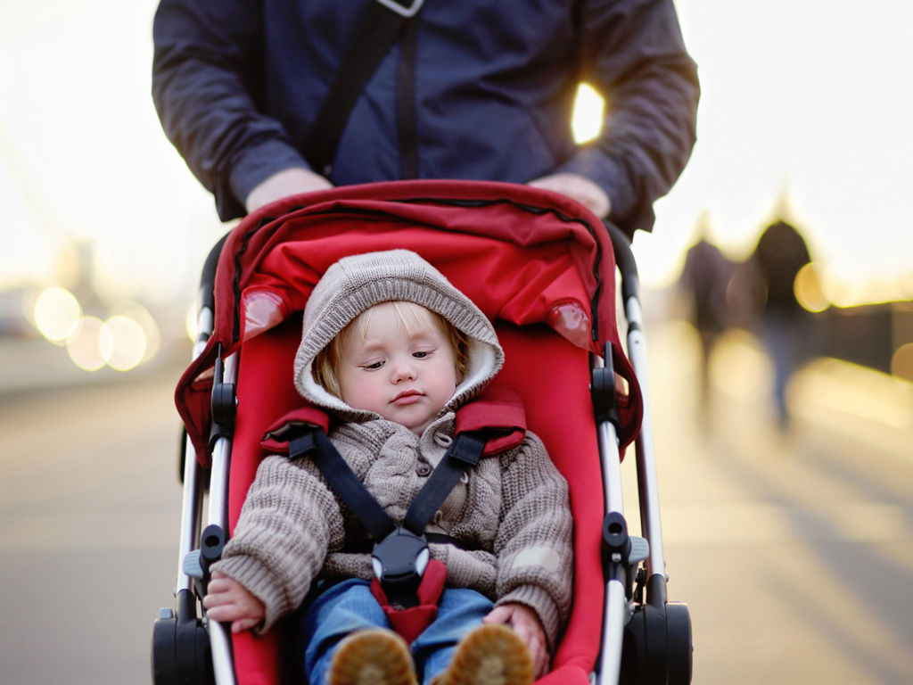 barn sidder i klapvogn